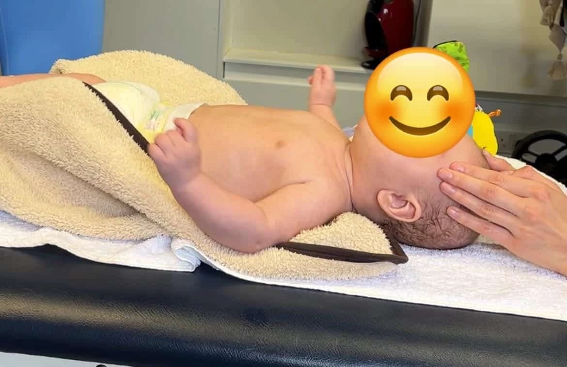 Gentle paediatric physiotherapy session with child receiving developmental support and postural assessment in a family-friendly environment